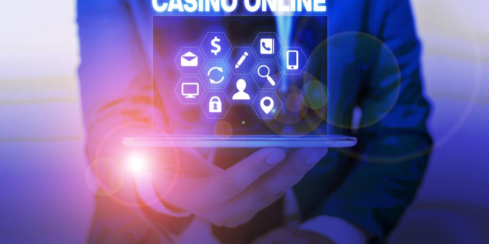 slots games in Canada image of a man holding a laptop with text casino online above it