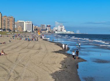 Ventnor City, New Jersey - September,2020: View from above a long beach at low tide from Ventnor City to Atlantic City showing large casino buildings in the distance